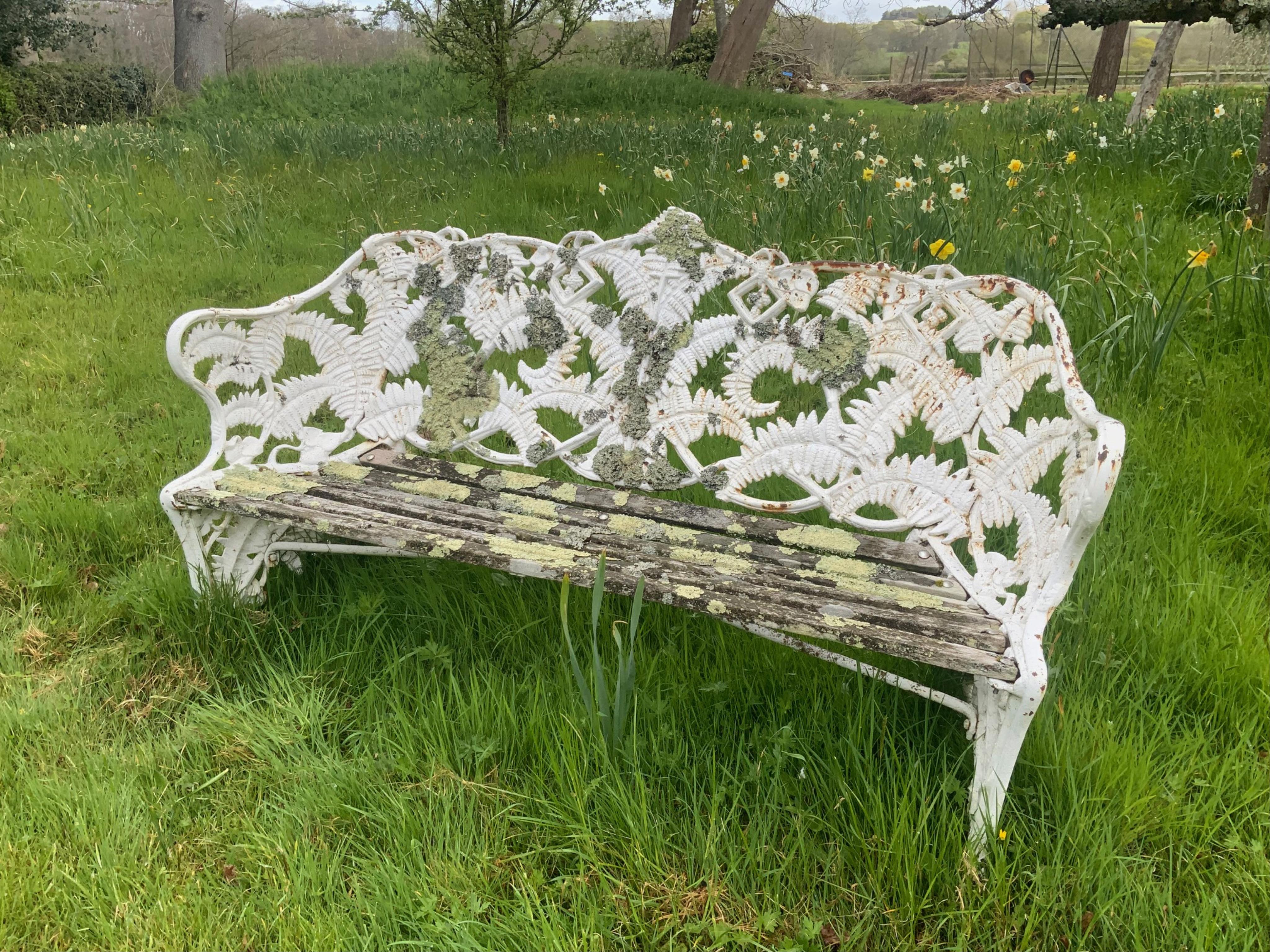A Victorian Coalbrookdale style fern pattern white painted cast iron garden bench, width 152cm, depth 56cm, height 91cm